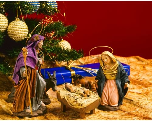 A beautifully crafted Christmas crib with miniature figurines representing the birth of Jesus.