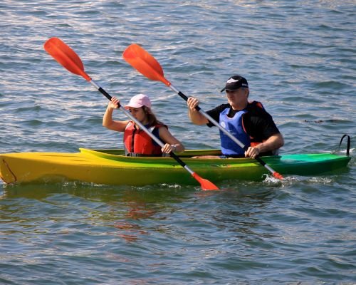 Couple enjoying a kayaking adventure on serene waters