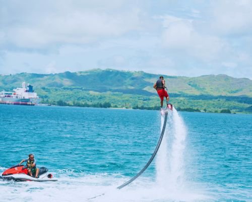 Man Flyboarding with Instructor on Jet Ski