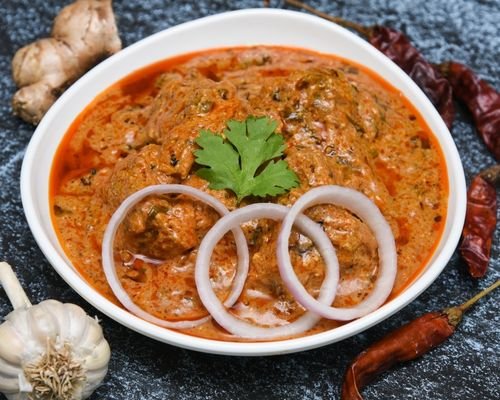 Goan Chicken Curry garnished with Coriander leaves on a plate