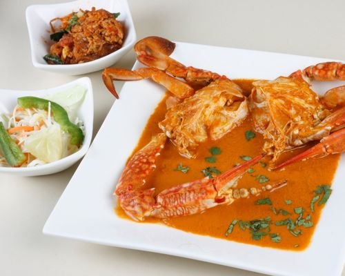 Goan Crab Curry with spices and Salad in a bowl