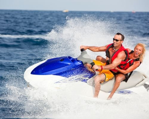 Couple riding jet ski on the water