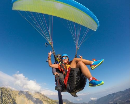 Woman Paragliding with Instructor