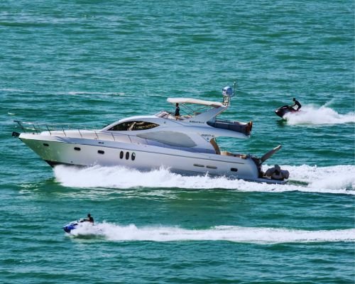 Party Boat Jet Ski - Customers enjoying thrilling jet ski adventure near the party boat.