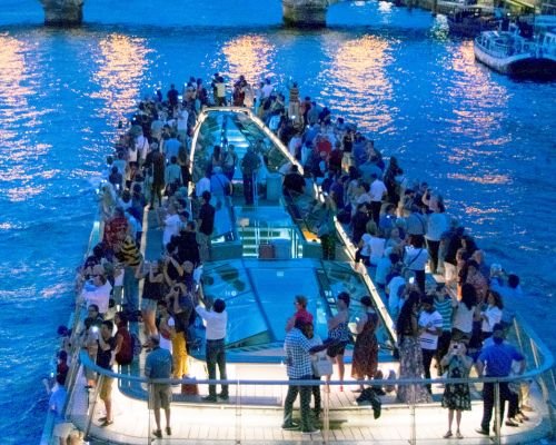 River Sundown Cruise - People on the rooftop of a small cruise ship enjoying the scenic view during the evening