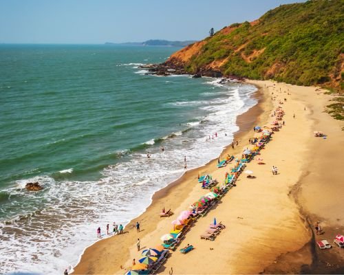 Breathtaking top view of Vagator Beach showcasing its scenic beauty, shoreline, and beach chairs.